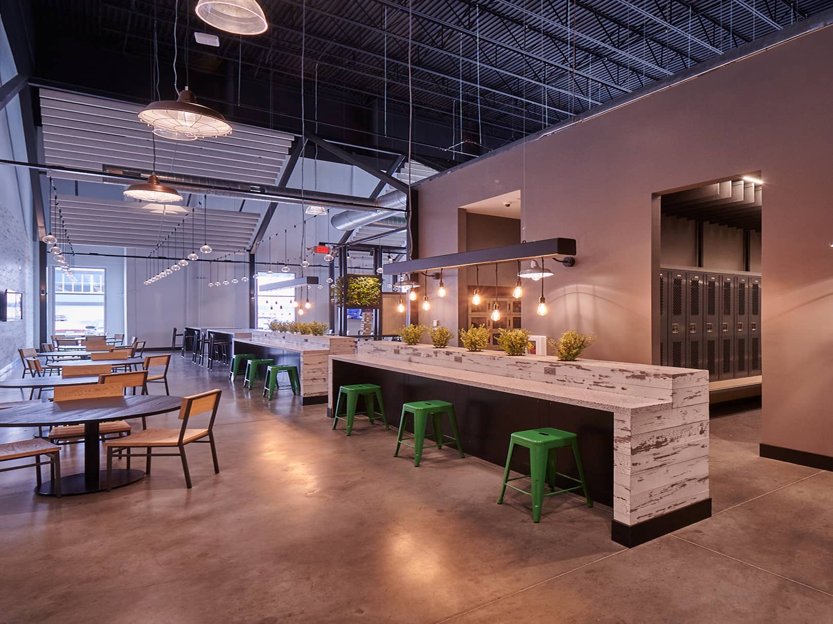Interior view of UNFI looking at seating bars and tables.
