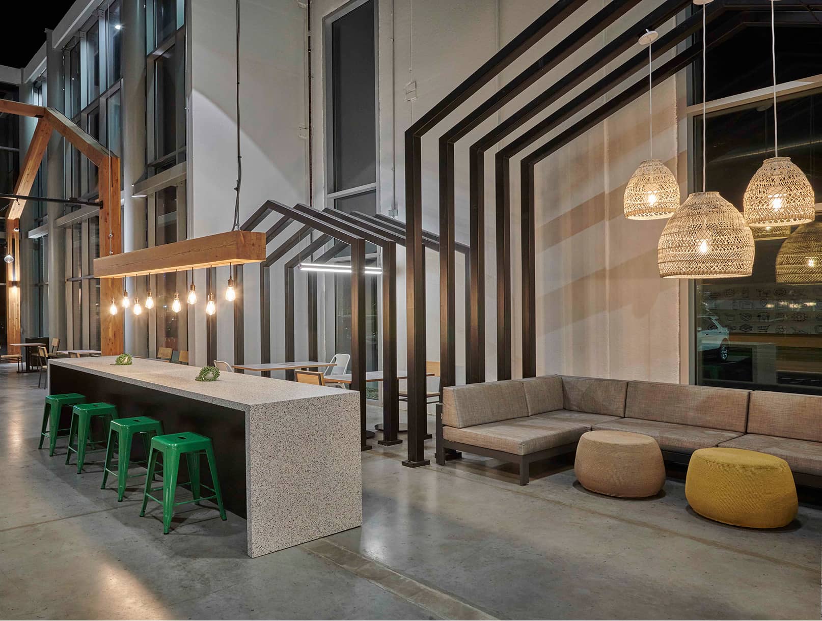 Interior view with seating and wooden gable structures to create interior spaces in a bigger space.