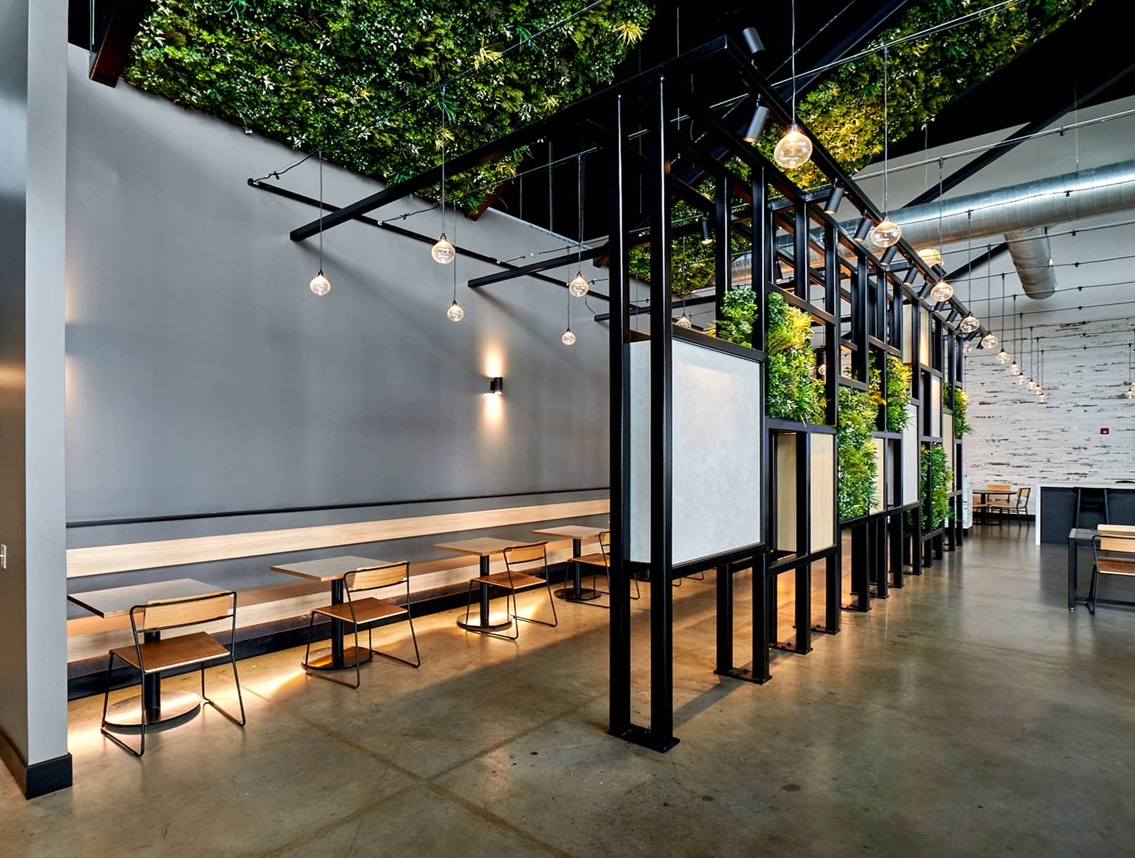 Open steel partition wall with greenery.