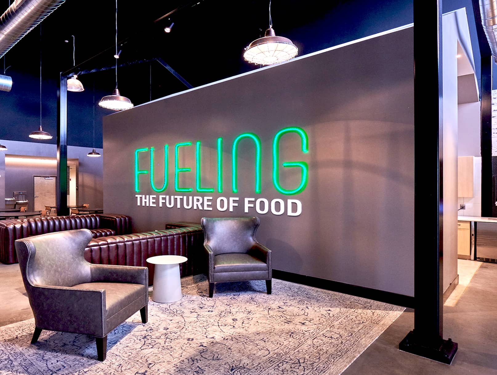 Branded wall with arm chairs and seating.
