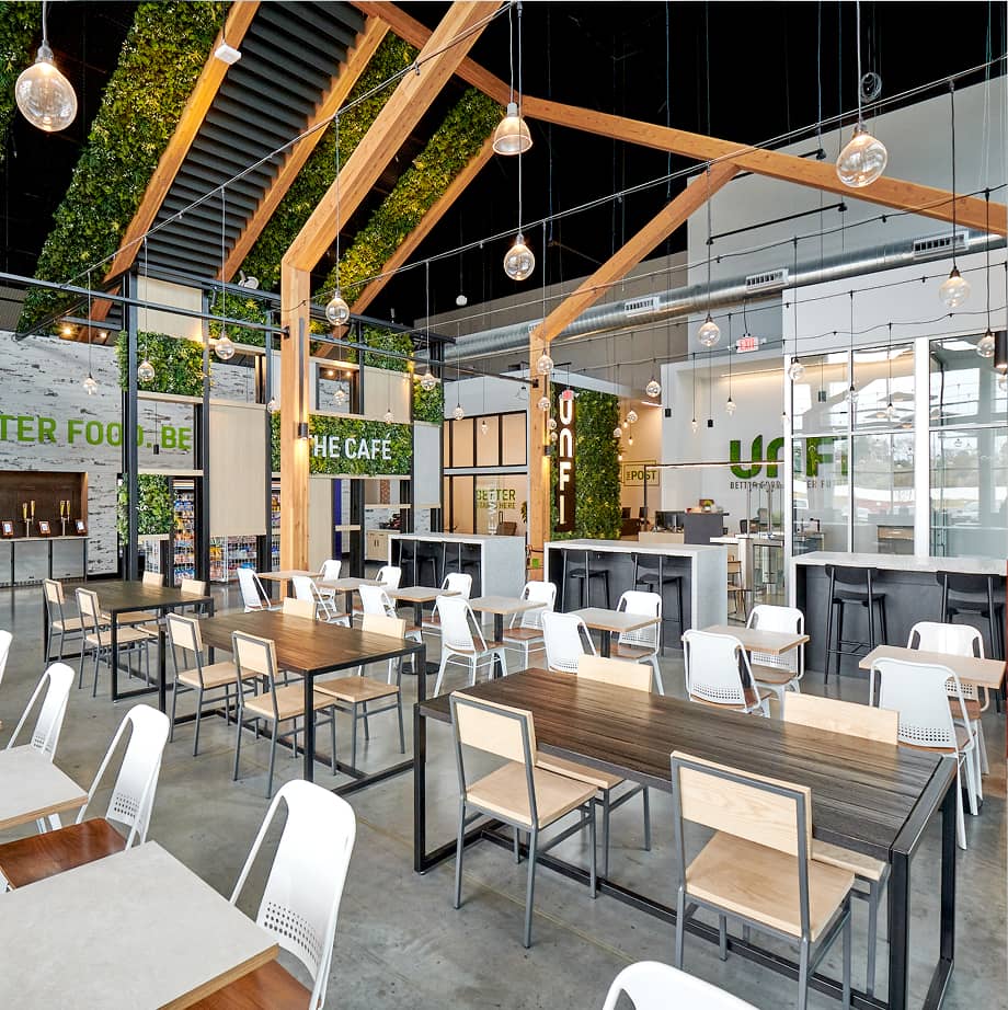 Interior view of UNFI with seating underneath wooden gable structure.