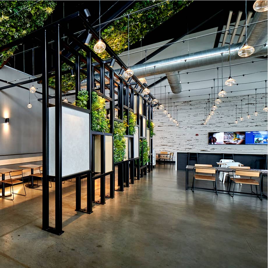 Interior view of UNFI with greenery woven into steel partition wall.