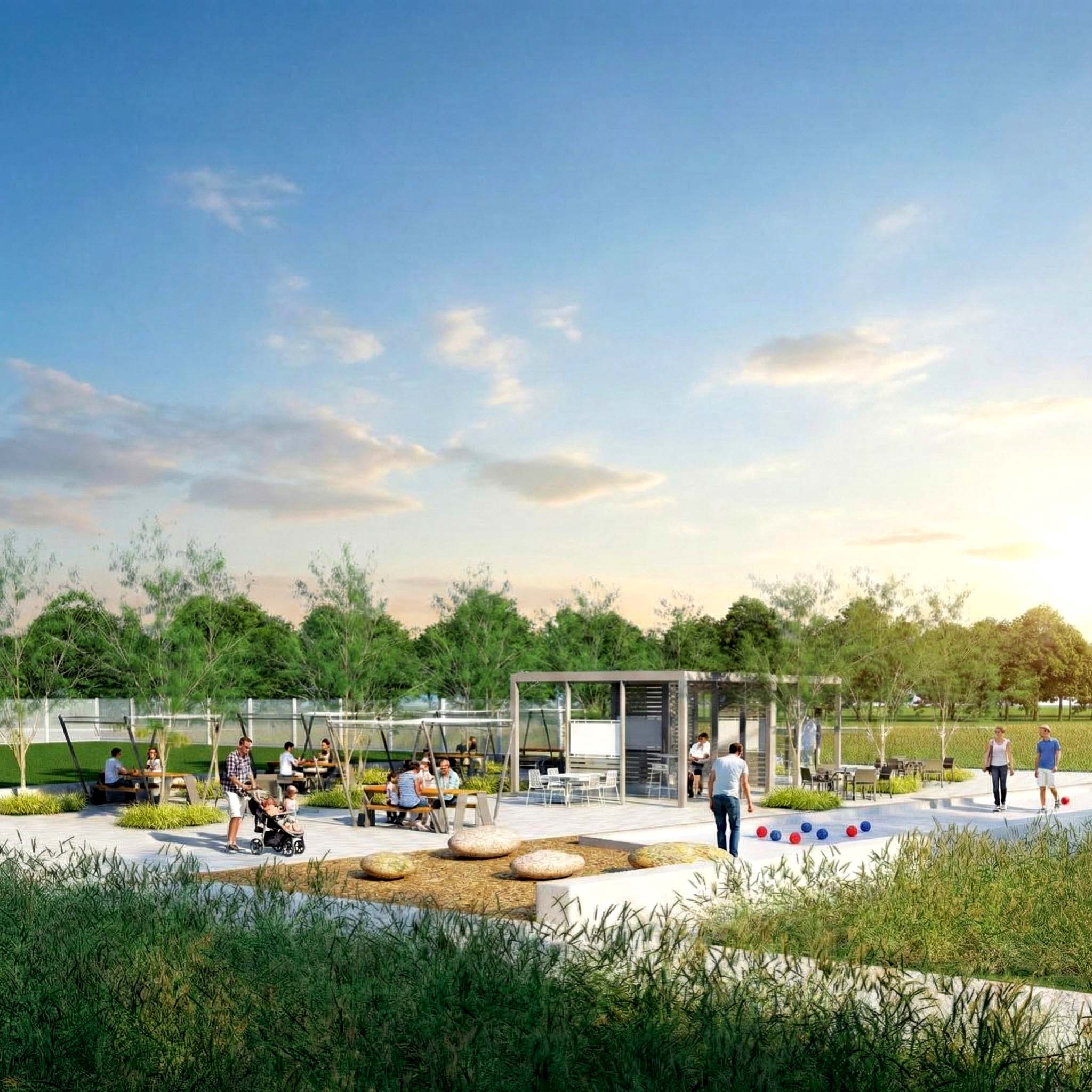 Outdoor community park with picnic tables, pavilion, and people gathering at sunset.