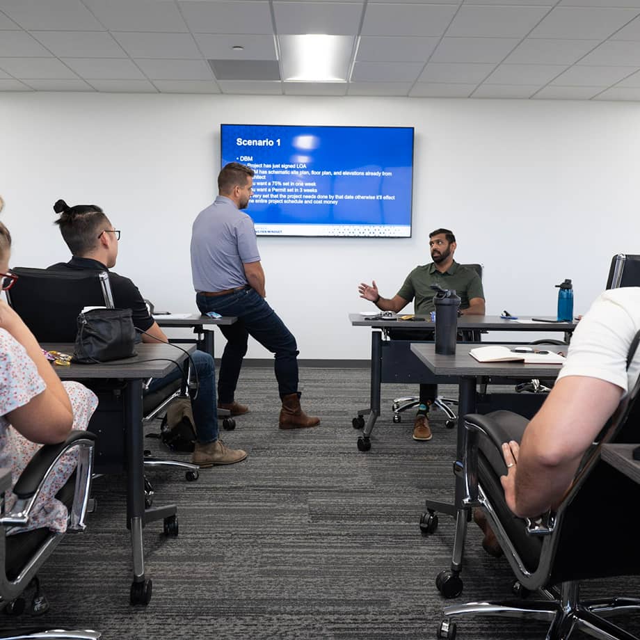 Team in a conference room discussing a project.