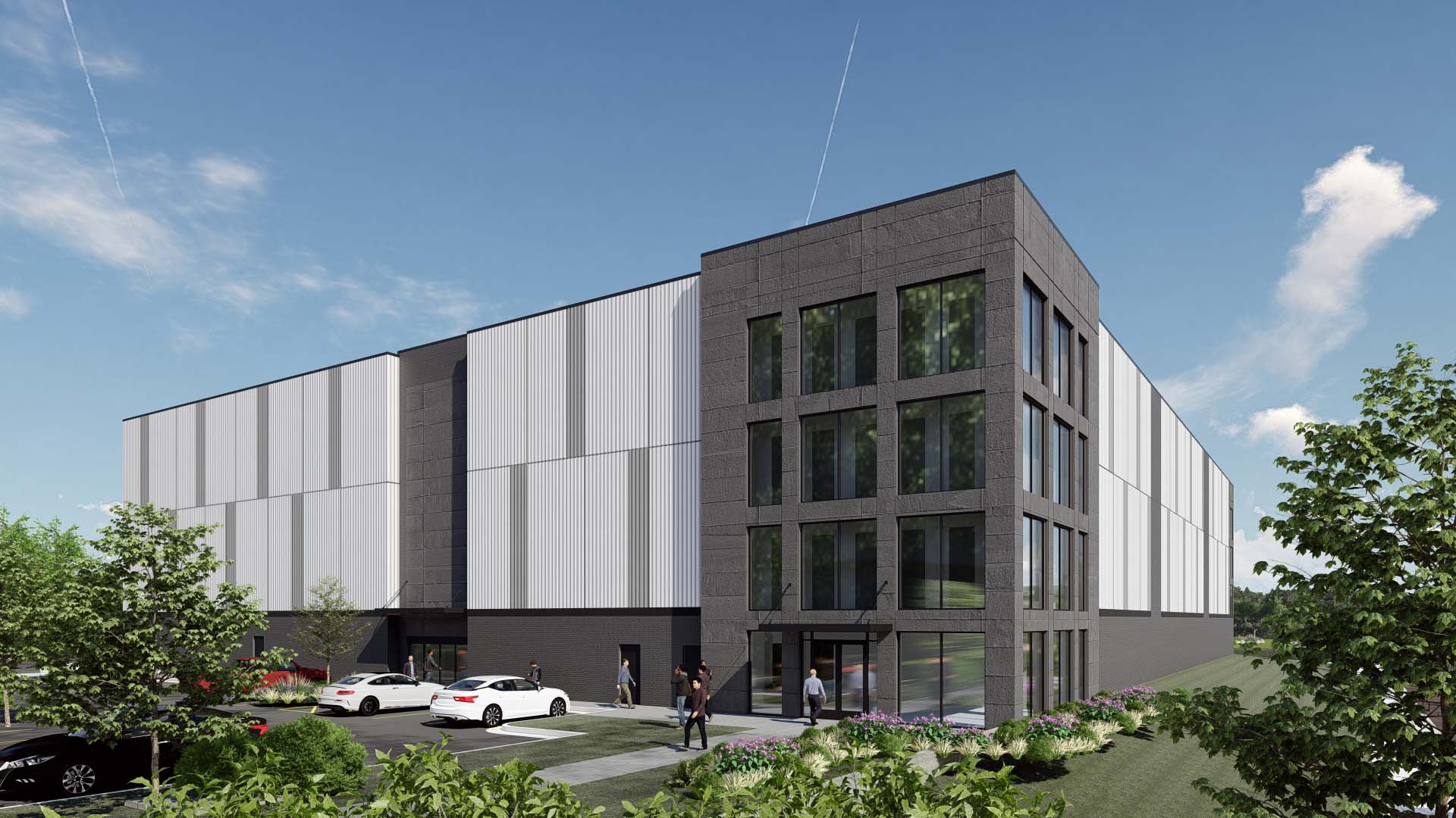 Exterior of self storage building with dark stone entrance, large windows, and metal panel facade.