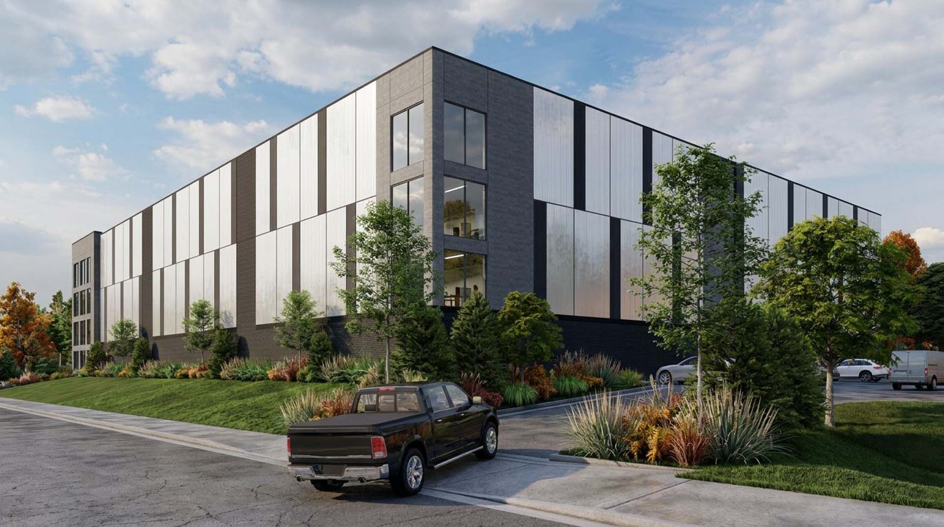 Exterior of modern self storage building with metal paneling, large windows, and landscaped entrance.